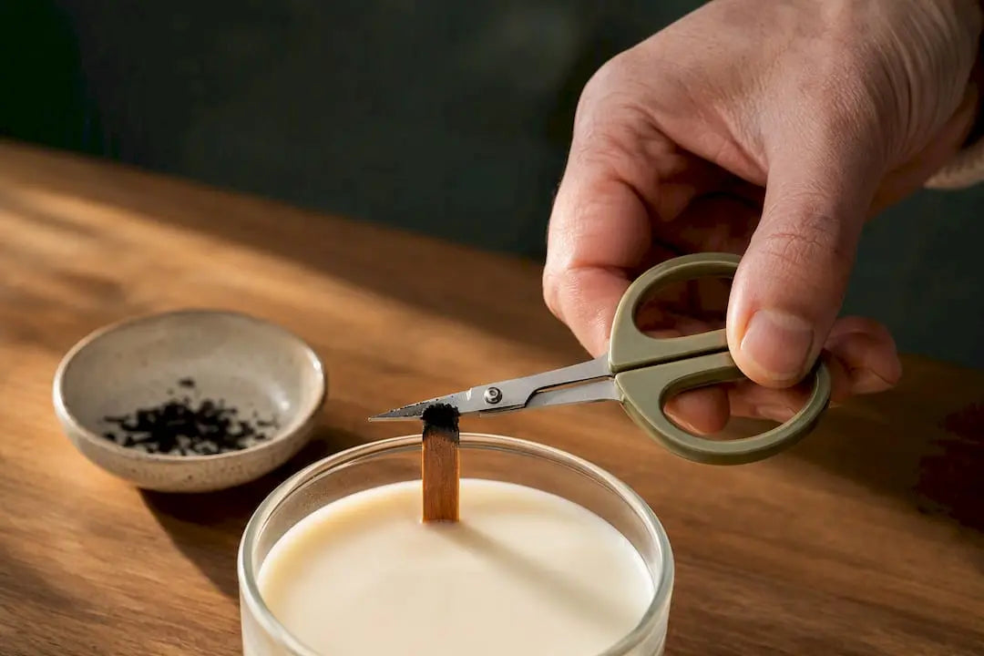 Hand trimming a charred wood wick