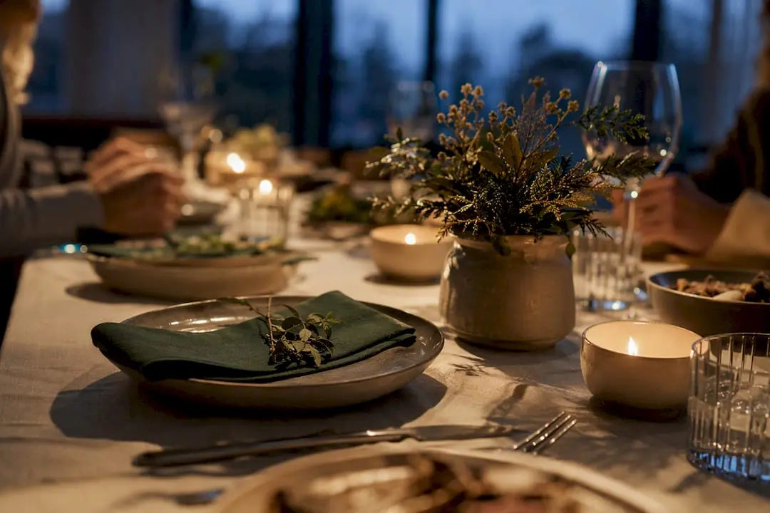 Dinner table glowing with candlelight