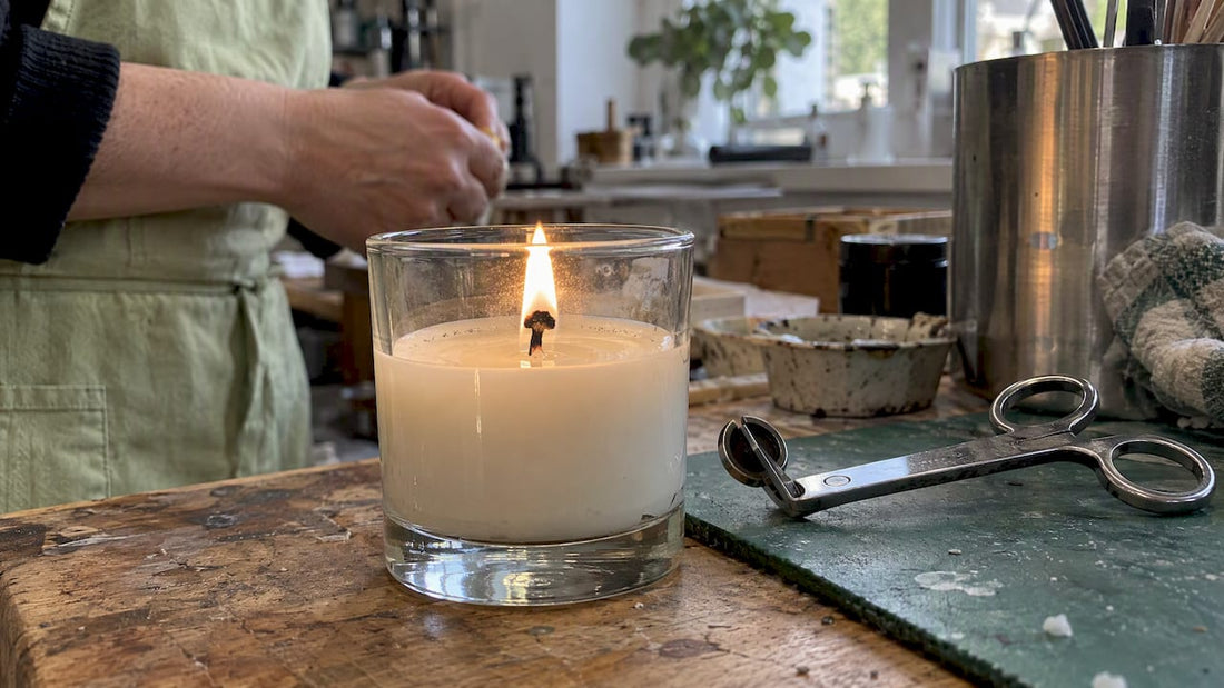 Candle flame beneath a mushroomed wick